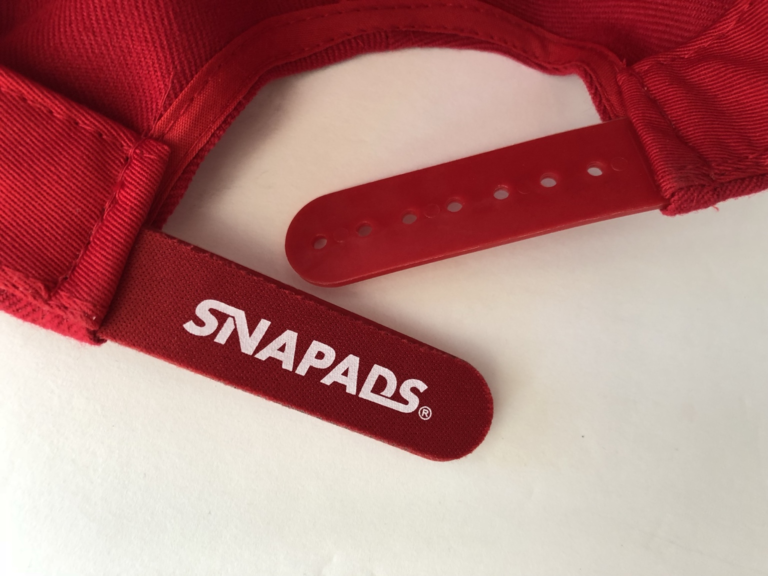Navy SnaPads cushion installed on a snapback